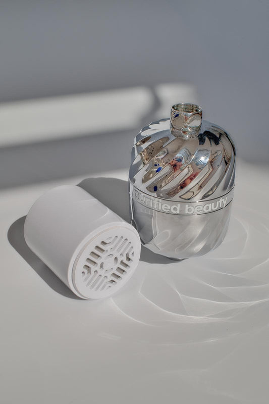 Purified Beauty cartridge beside the chrome shower filter