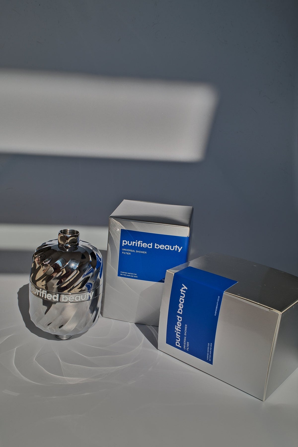 Purified Beauty chrome shower filter with packaging boxes