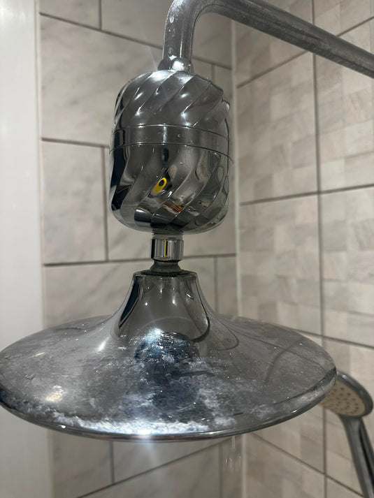 Purified Beauty shower filter fitted above a rain shower head in a customer's bathroom